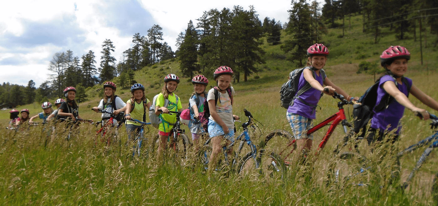 girls biking at summer camp