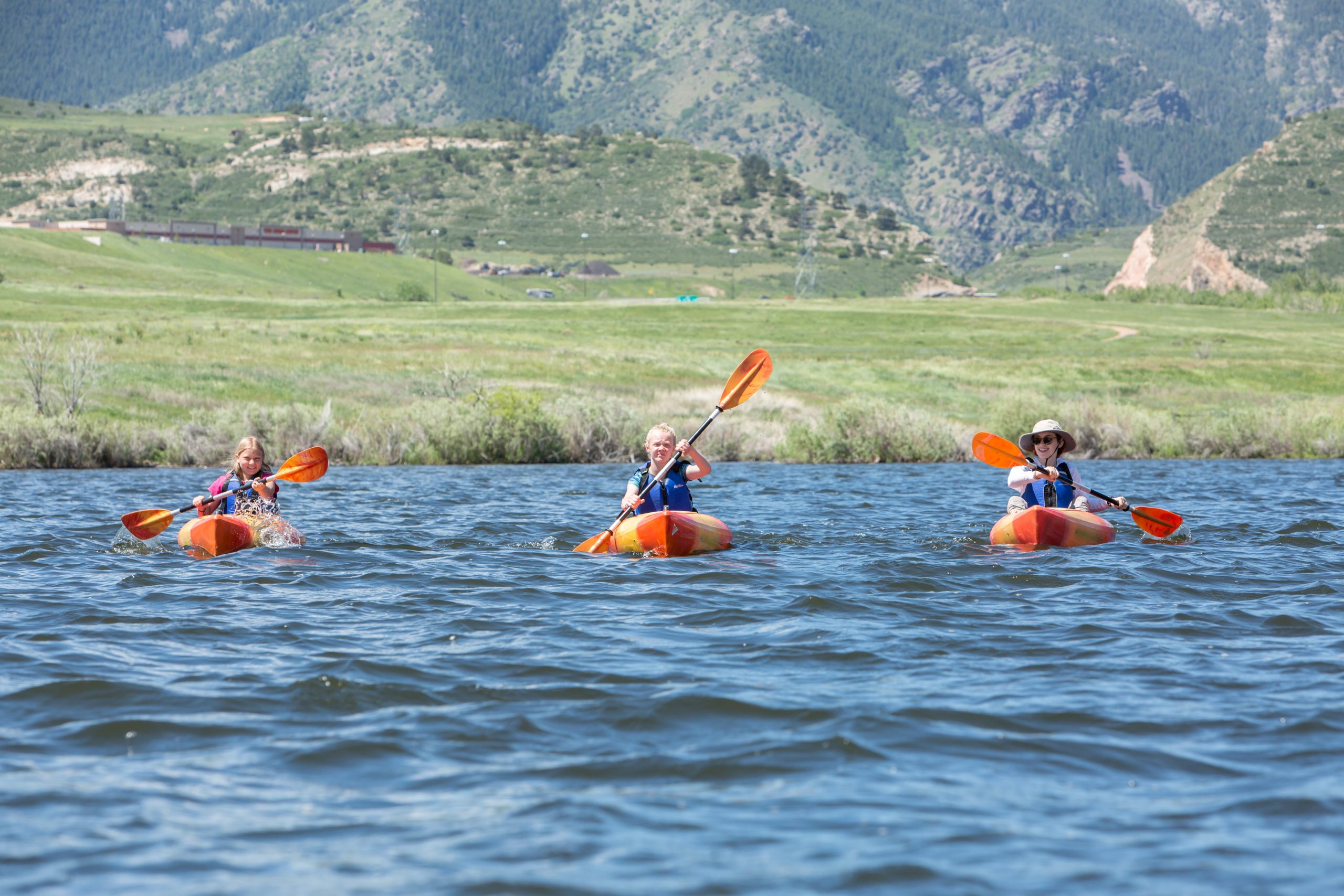 Kids kayaking in a lake at summer camp